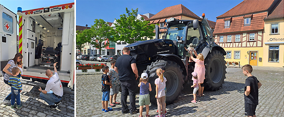 Bild 1: Franz Männling, Notfallsanitäter BRK-Rettungswache Haßfurt, erklärt den Familien wie das Einsatzfahrzeug funktioniert und welche Ausrüstung sie immer dabeihaben. | Bild 2: Landwirt, Johannes Werner aus Wonfurt, beantwortet alle neugierigen Fragen der Kinder und zeigt ihnen die Funktionen des Bulldogs. (Fotos: Jennifer Nüßlein, MGH)